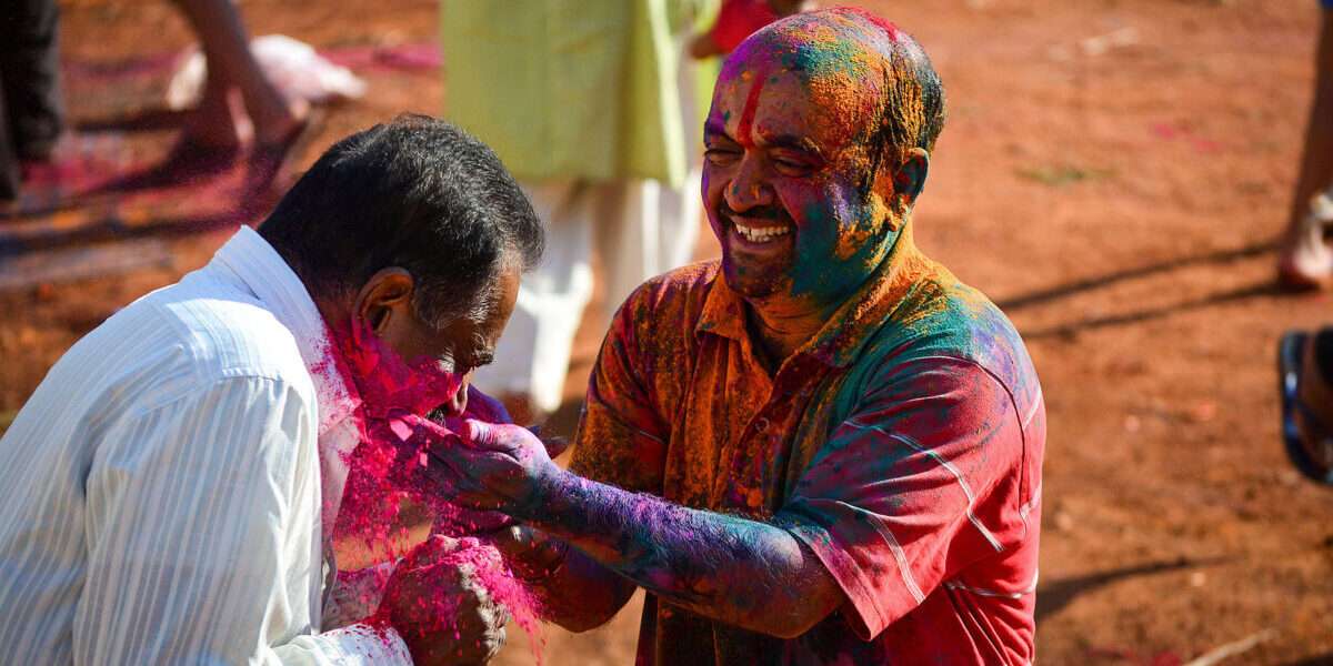Two people playing Holi, the Festival of Colors - 10 Sacred Festivals in Hinduism